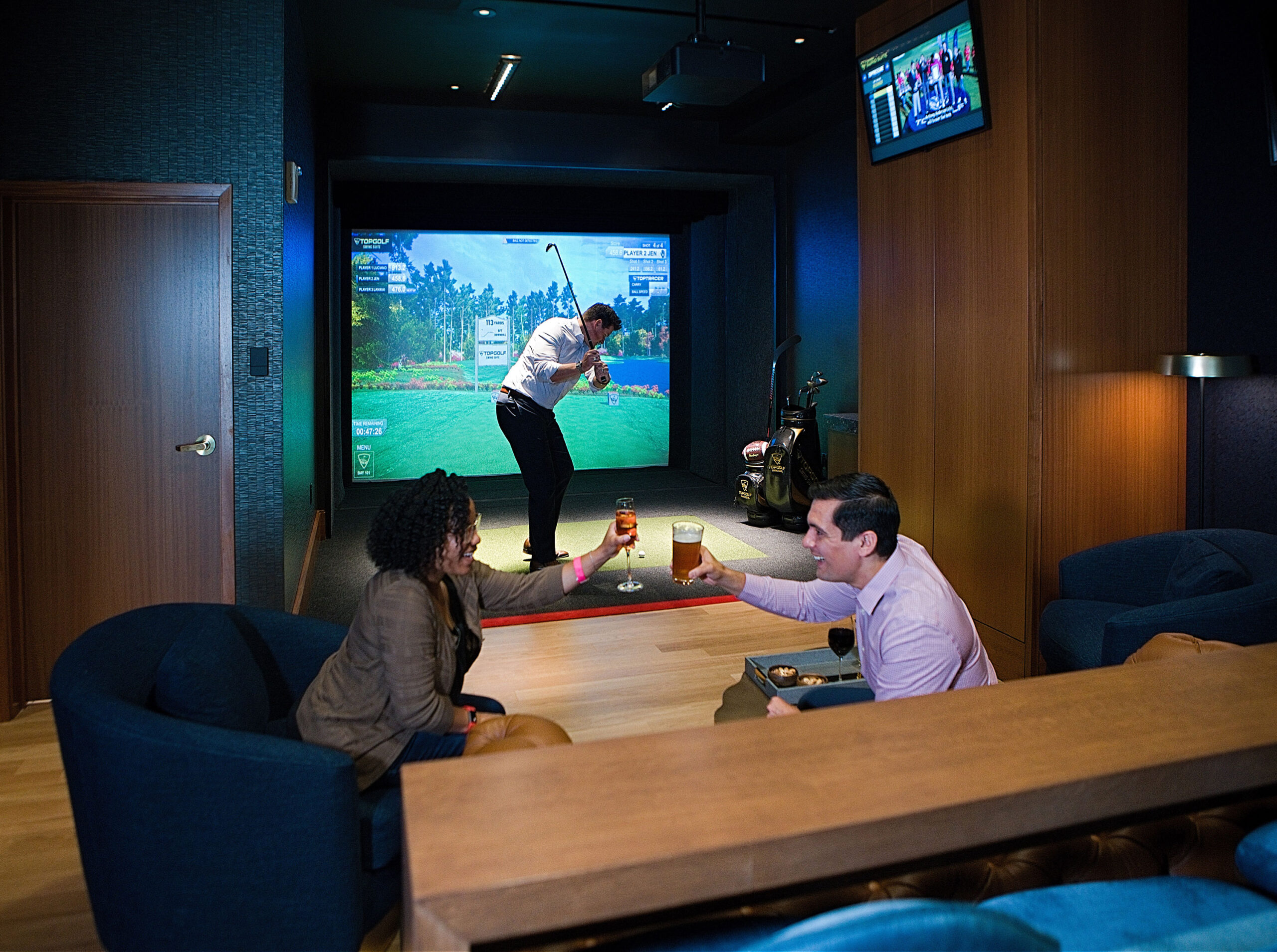 Top Golf suite with a man playing their golf VR game