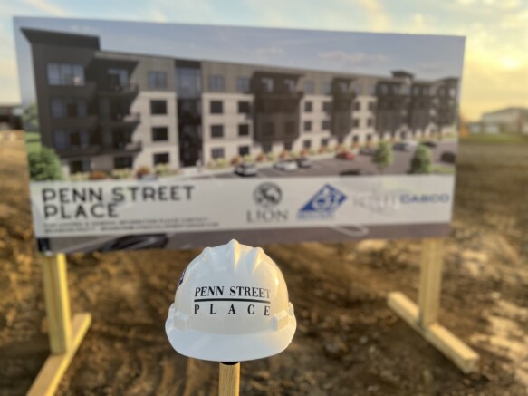 Penn Street Place Construction Hat in front of site signage