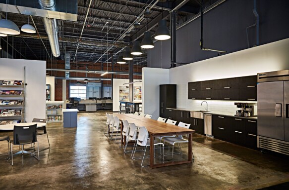 CD Companies kitchenette/lunch room with long wood table and dark wood cabinets